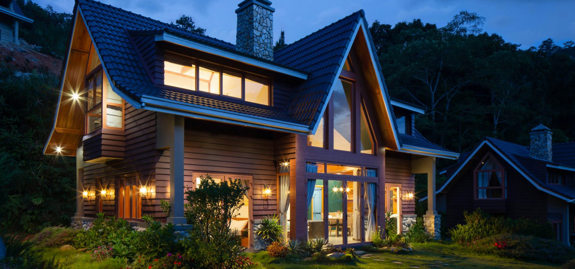 A custom home glowing at dusk